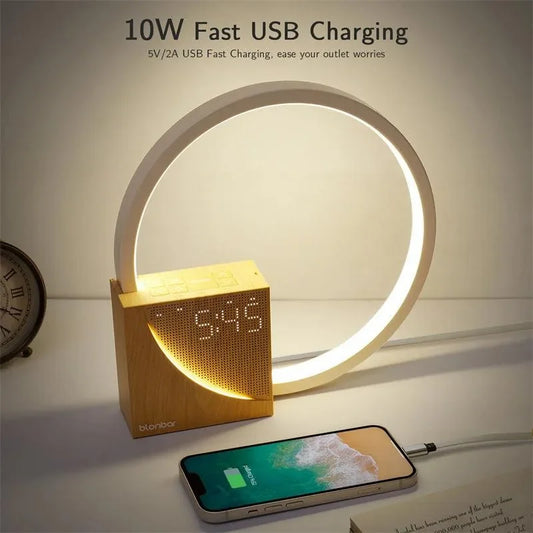 Modern wooden digital clock with LED display and a circular white LED desk lamp charging a smartphone
