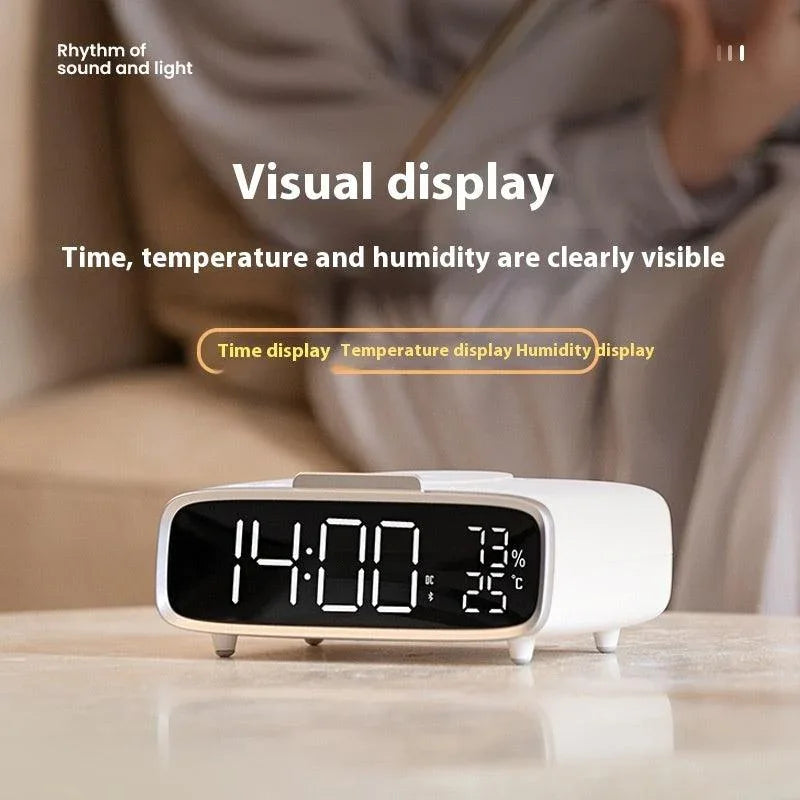 Modern digital clock displaying time 14:00, humidity 73%, and temperature 25°C on a white table