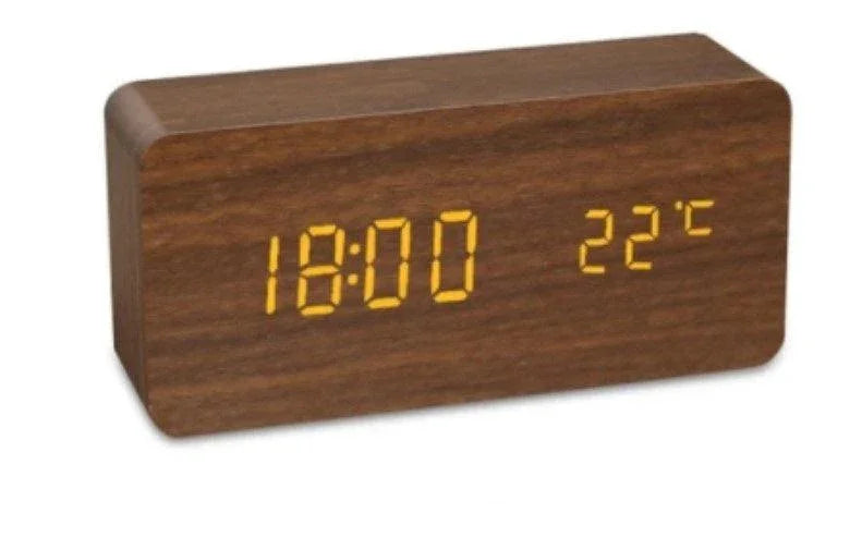 Wooden digital alarm clock displaying 18:00 and 22°C temperature in amber LED