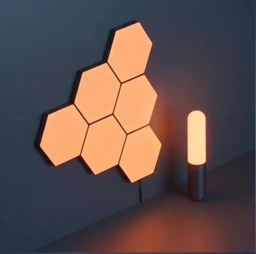Hexagonal smart LED wall lights and modern cylinder lamp with soft orange glow in a minimalist room