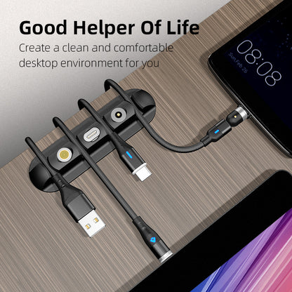 Magnetic cable organizer holding charging cables on a wooden desk next to a tablet