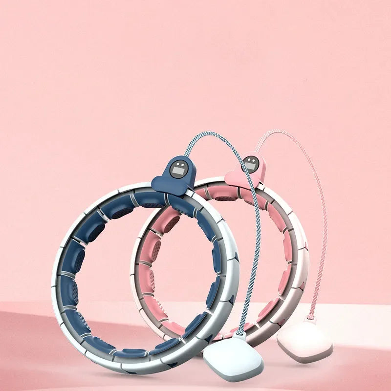 Adjustable smart weighted hula hoops in blue and pink for fitness on a pink background