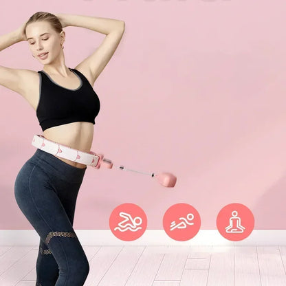 Woman using a smart weighted hula hoop for fitness exercise indoors, pink background