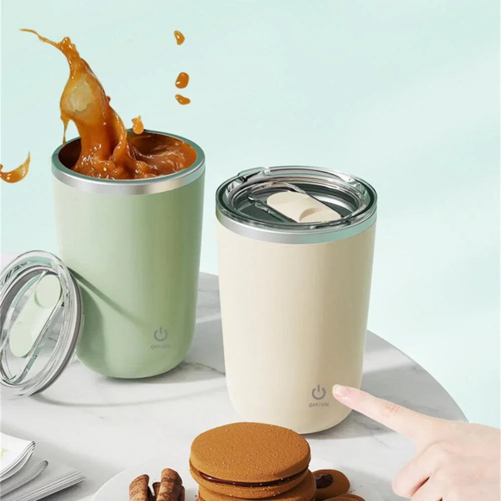 Automatic self-stirring mugs with lids, one mixing coffee, on a table with biscuits.