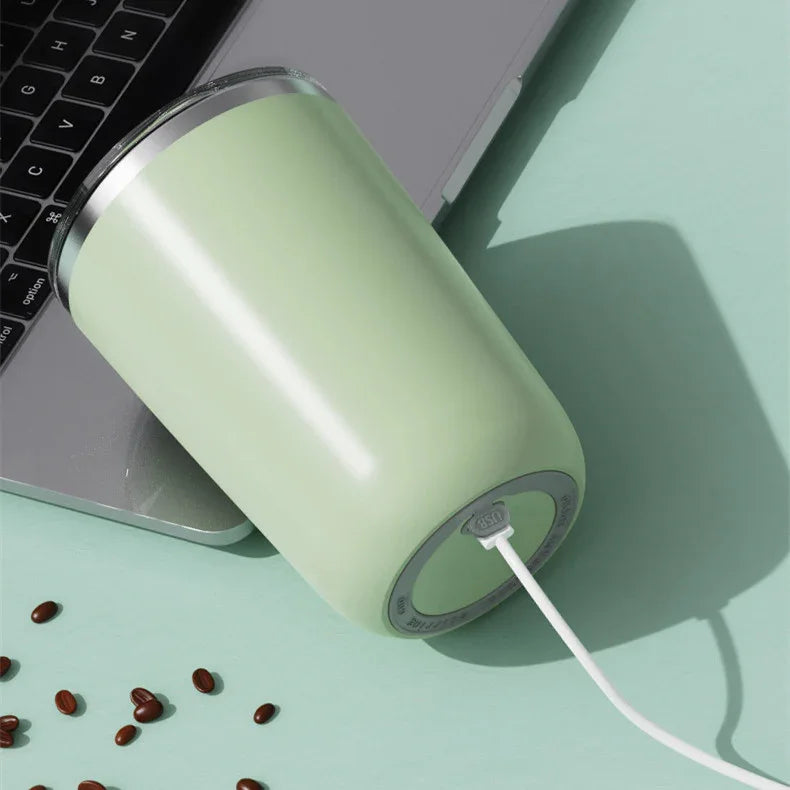 USB rechargeable smart mug on laptop with coffee beans on mint green background