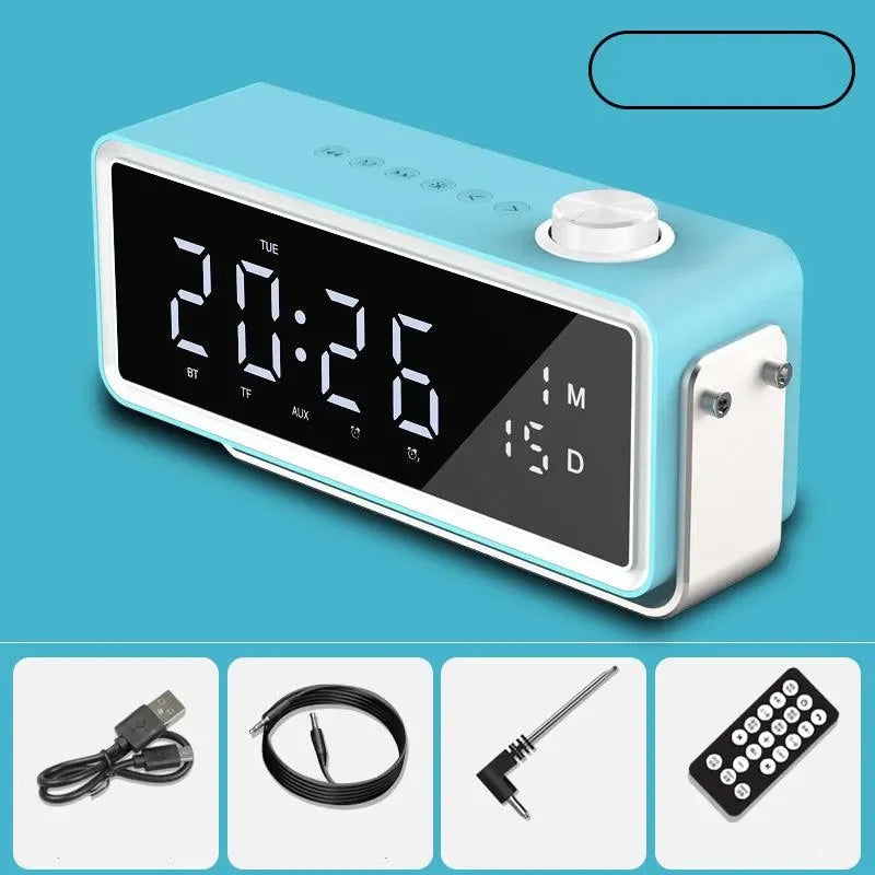 Blue digital alarm clock showing 20:26 with date display, USB cable, audio cable, adapter, and remote control