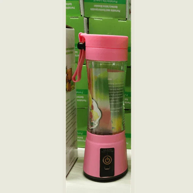 Portable pink electric blender with power button and carrying strap displayed on shelf