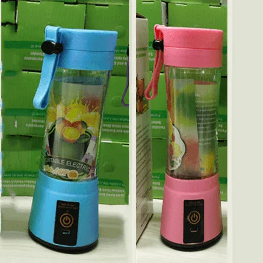 Blue and pink portable electric blenders with carrying straps on a white surface against green boxes